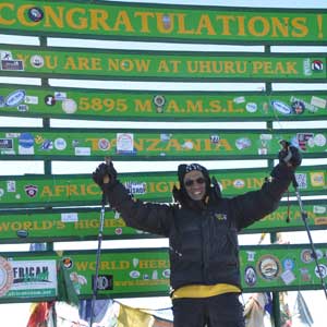 Akil Taher at the summit of Mt. Kilimanjaro.